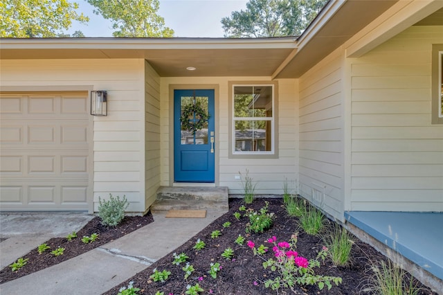 entrance to property featuring an attached garage