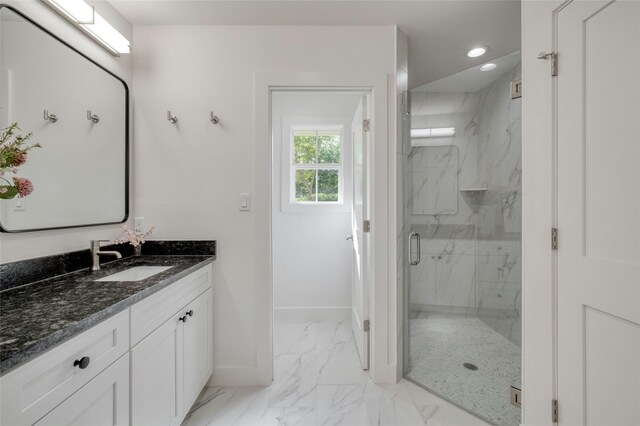 full bathroom with recessed lighting, vanity, baseboards, marble finish floor, and a marble finish shower