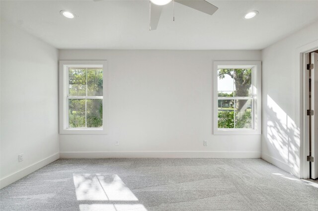 unfurnished room featuring carpet, a wealth of natural light, and recessed lighting