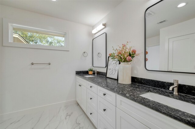 full bath with marble finish floor, baseboards, visible vents, and a sink