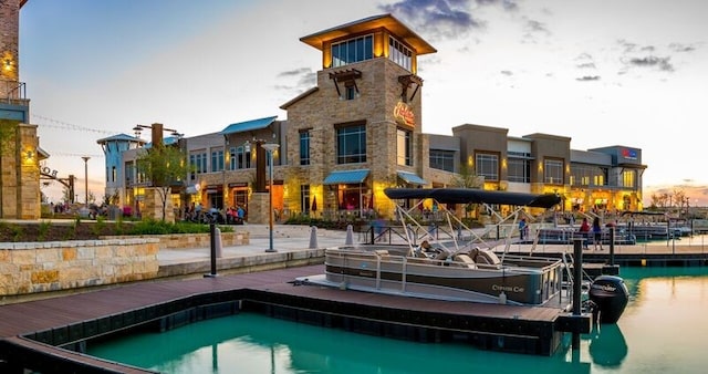 exterior space featuring stone siding and a water view