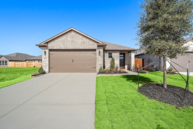 view of front facade with a garage, driveway, fence, a front lawn, and brick siding