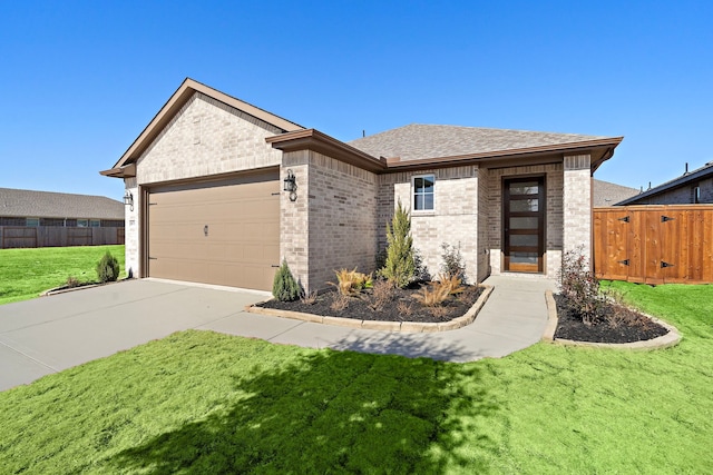 view of front of house featuring brick siding, an attached garage, fence, driveway, and a front lawn