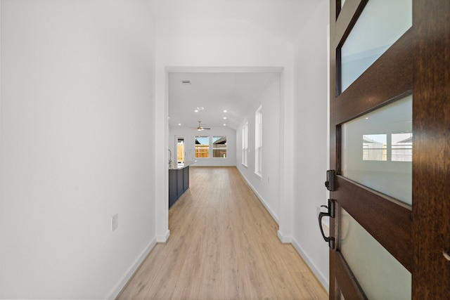 corridor with recessed lighting, baseboards, and light wood finished floors