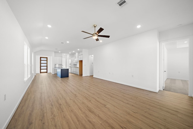 unfurnished living room with recessed lighting, visible vents, ceiling fan, and light wood-style flooring