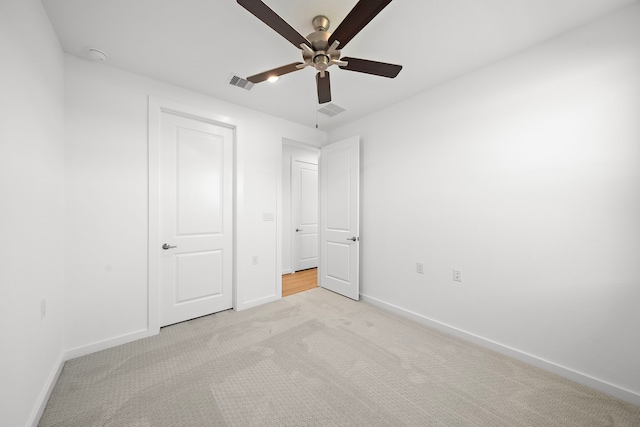 unfurnished bedroom with visible vents, ceiling fan, light carpet, and baseboards