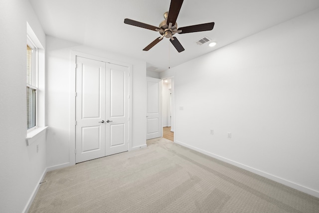 unfurnished bedroom with light carpet, baseboards, and visible vents