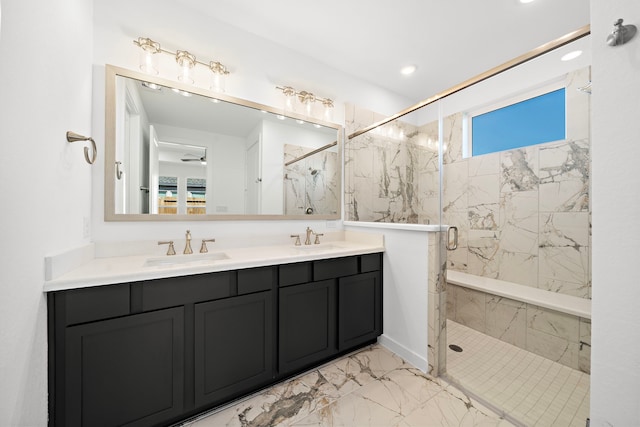 bathroom with marble finish floor, double vanity, a sink, and a marble finish shower