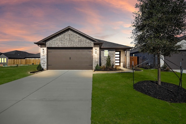 view of front of house featuring a garage, concrete driveway, a lawn, and fence