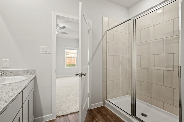 bathroom with vanity, hardwood / wood-style flooring, and a shower with door