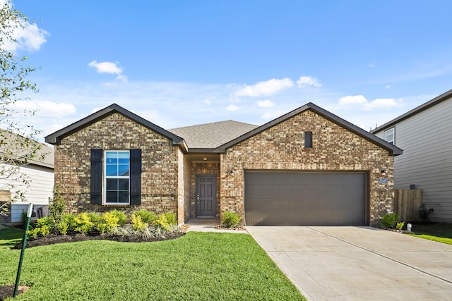 view of front of home with a garage and a front lawn