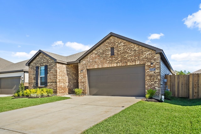 view of front of house with a garage and a front lawn