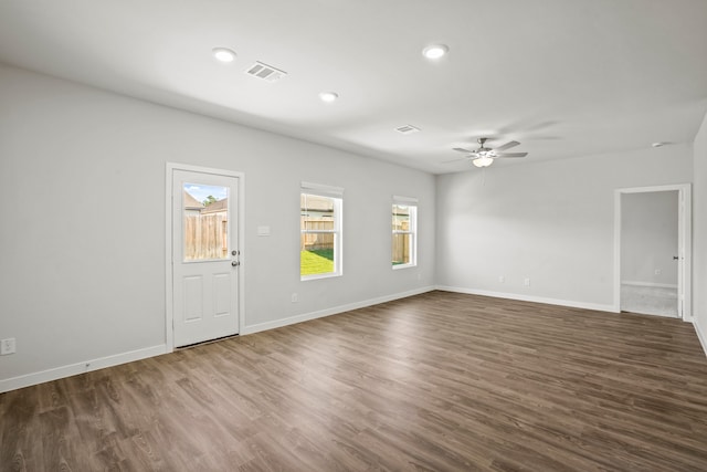 unfurnished room featuring dark hardwood / wood-style floors and ceiling fan