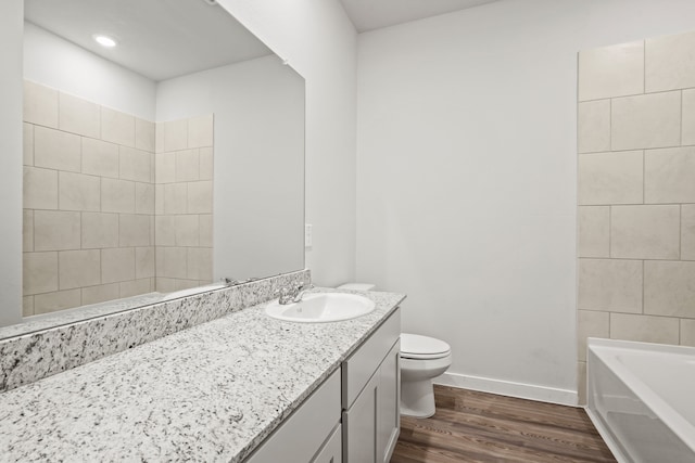 bathroom featuring wood-type flooring, toilet, and vanity