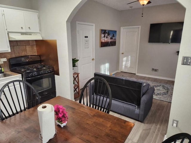 dining area with ceiling fan and wood-type flooring