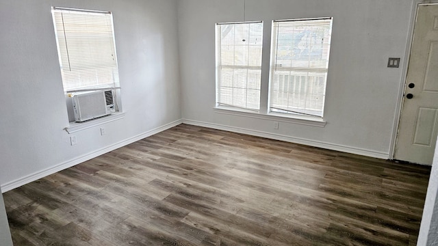 interior space featuring cooling unit, a wealth of natural light, and dark wood-type flooring