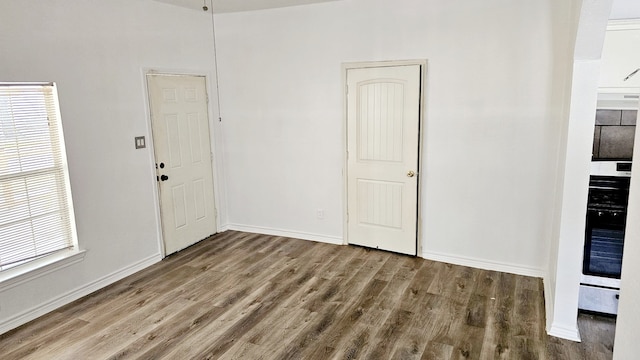 unfurnished room featuring hardwood / wood-style floors