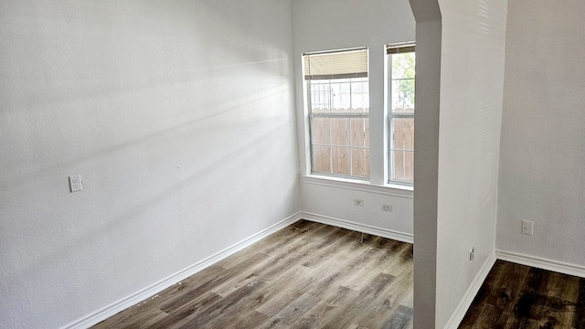 unfurnished room featuring hardwood / wood-style flooring