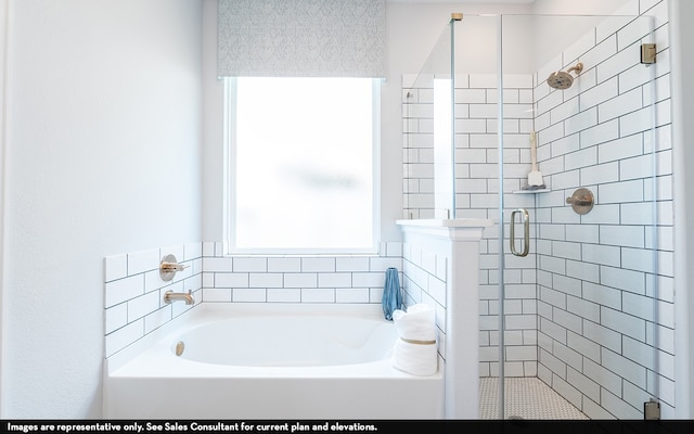 bathroom featuring independent shower and bath