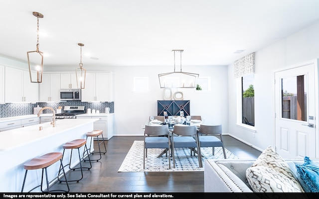 dining space featuring sink and dark hardwood / wood-style flooring