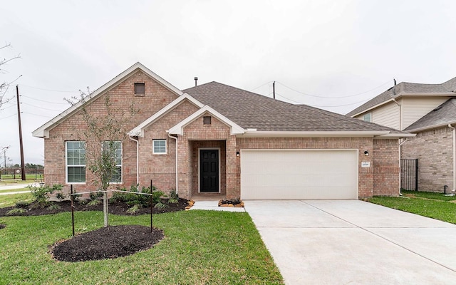 view of front facade with a garage and a front yard