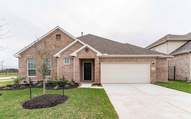 ranch-style home with brick siding, a garage, a front lawn, and concrete driveway