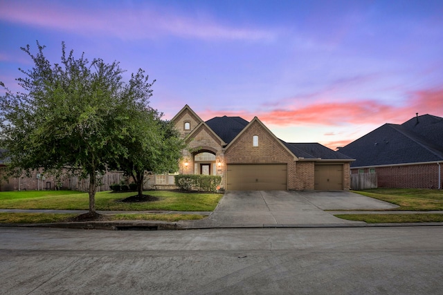 view of front of house with a garage and a lawn