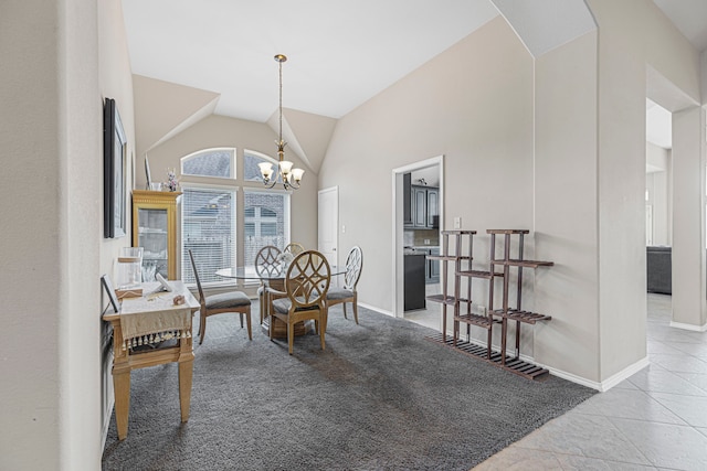 dining area with light tile patterned floors, high vaulted ceiling, and an inviting chandelier