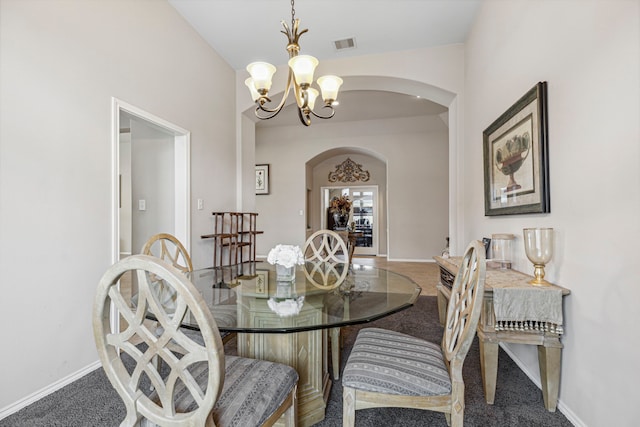 dining room with a notable chandelier and carpet