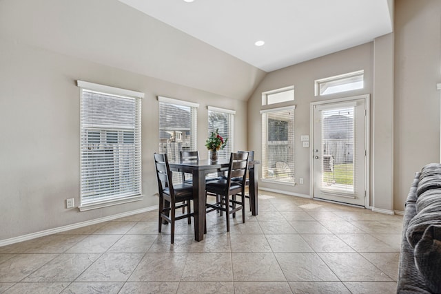 dining area with vaulted ceiling and light tile patterned floors