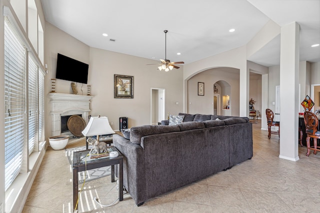 tiled living room featuring plenty of natural light and ceiling fan