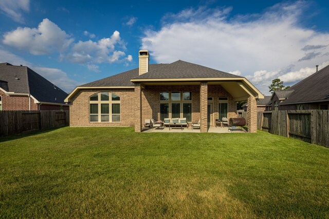 rear view of house with a patio area and a yard