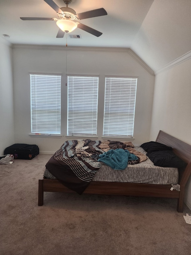 carpeted bedroom with crown molding, ceiling fan, and lofted ceiling