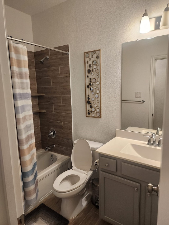 full bathroom featuring shower / bath combo, vanity, hardwood / wood-style flooring, and toilet