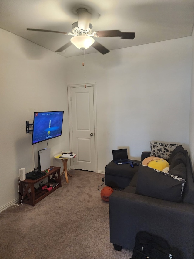 sitting room with ceiling fan and carpet