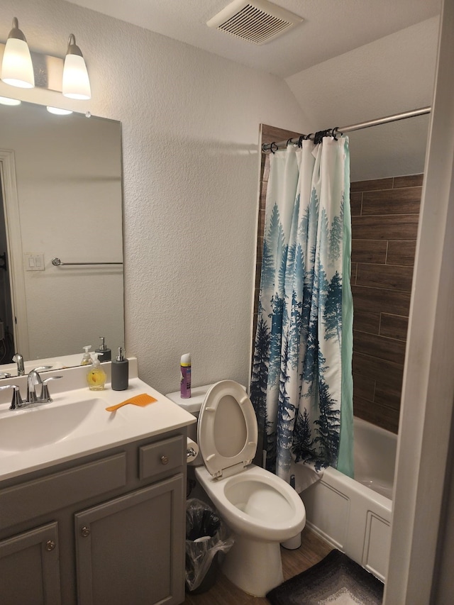 full bathroom featuring toilet, shower / tub combo, vanity, and vaulted ceiling