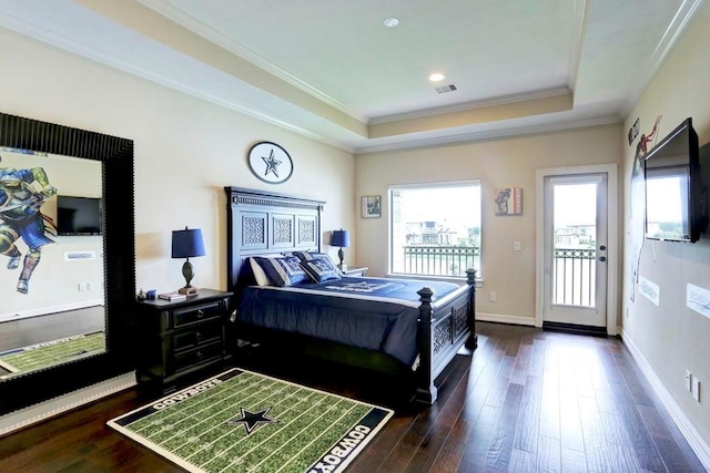 bedroom featuring dark hardwood / wood-style flooring, a raised ceiling, access to exterior, and ornamental molding