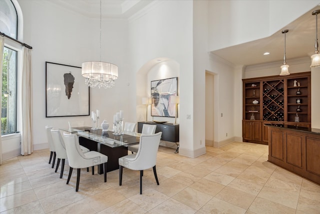 tiled dining space with a notable chandelier, crown molding, and a high ceiling