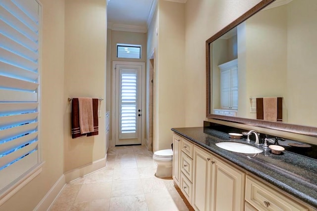 bathroom with crown molding, toilet, tile patterned floors, and vanity