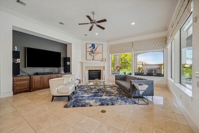 living room featuring ceiling fan, light tile patterned flooring, and ornamental molding