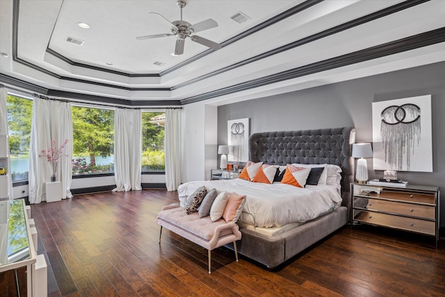 bedroom featuring ceiling fan, a raised ceiling, dark hardwood / wood-style floors, and crown molding