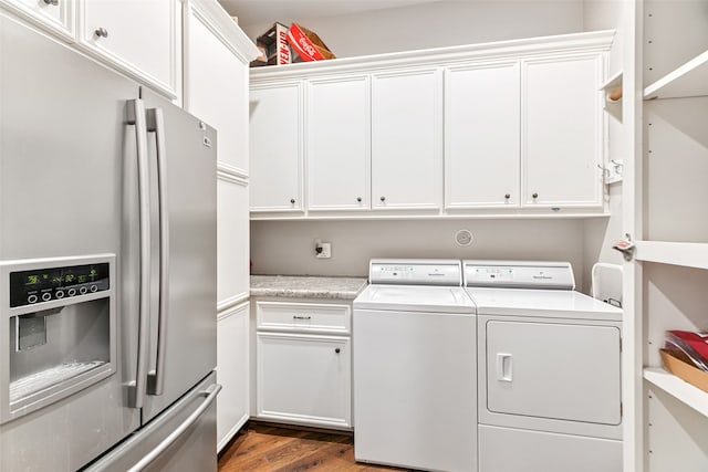 laundry room featuring hardwood / wood-style flooring, cabinets, and separate washer and dryer