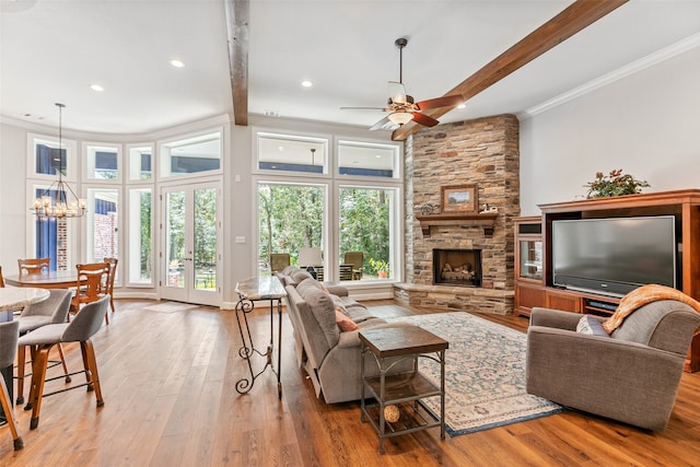 living room featuring a fireplace, ornamental molding, light hardwood / wood-style floors, and beamed ceiling