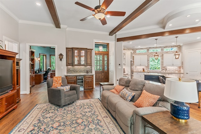 living room with hardwood / wood-style flooring, ceiling fan, a healthy amount of sunlight, and beverage cooler