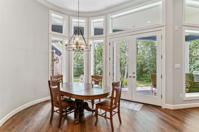 dining room with a chandelier, dark hardwood / wood-style floors, and french doors