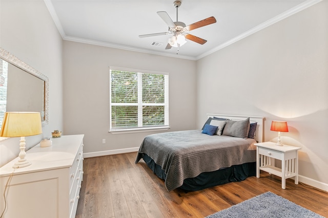 bedroom with light wood-type flooring, ceiling fan, and ornamental molding