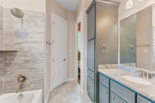 bathroom with tiled shower / bath combo and vanity