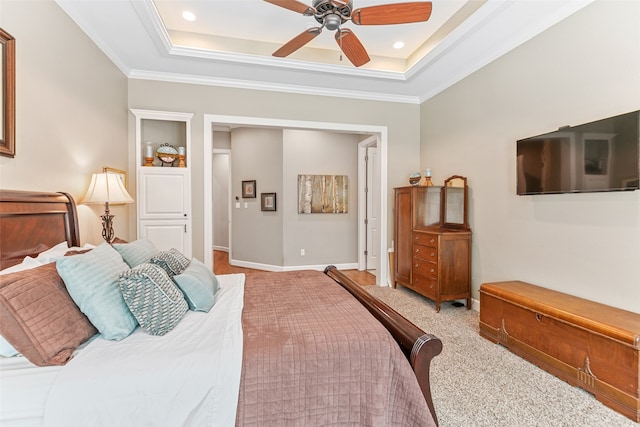 bedroom featuring light colored carpet, a raised ceiling, ceiling fan, and ornamental molding