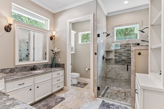 bathroom featuring vanity, toilet, a shower with door, and ornamental molding