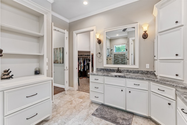 bathroom with vanity, a shower, and ornamental molding